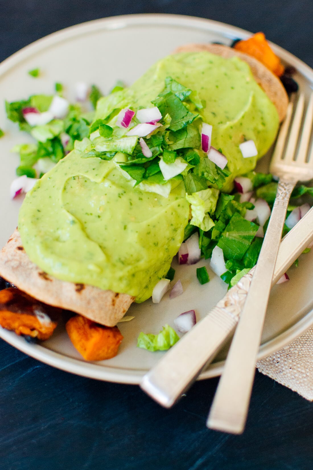 Sweet potato burrito smothered with avocado salsa verde from cookieandkate.com Sweet potato burrito smothered with avocado salsa verde